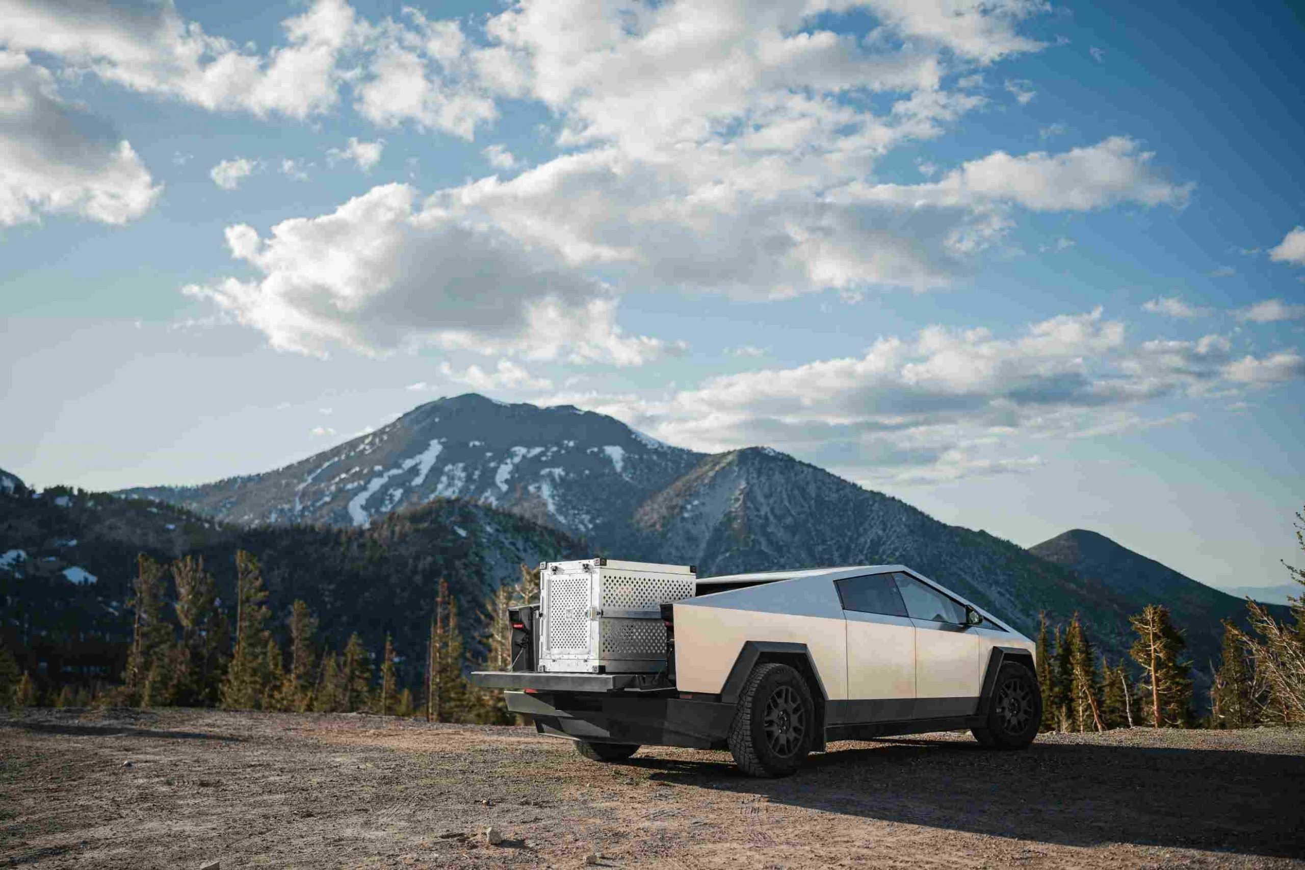 A Cybertruck parked in a mountainous environment.