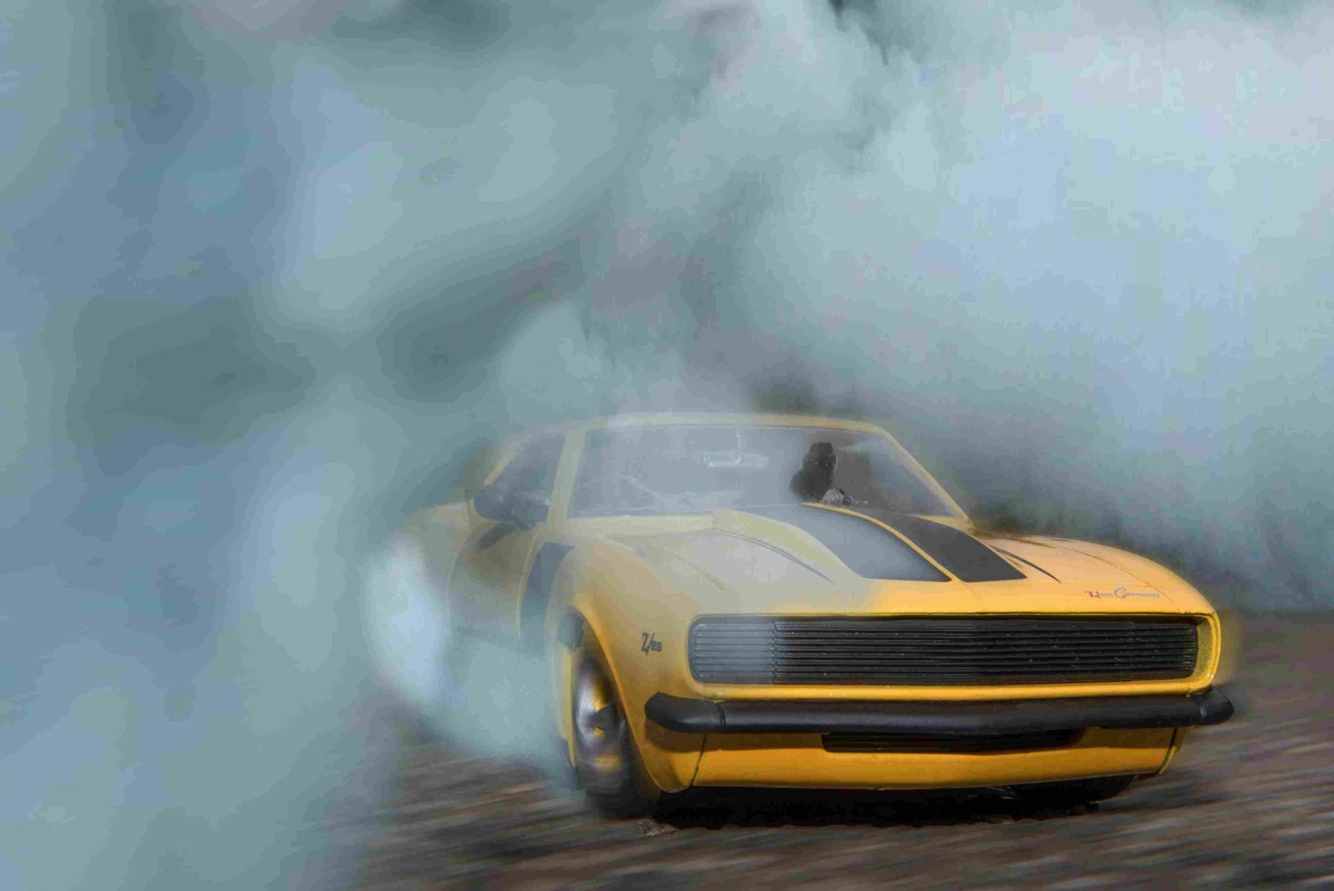 A sportscar drifting in a cloudy setting.