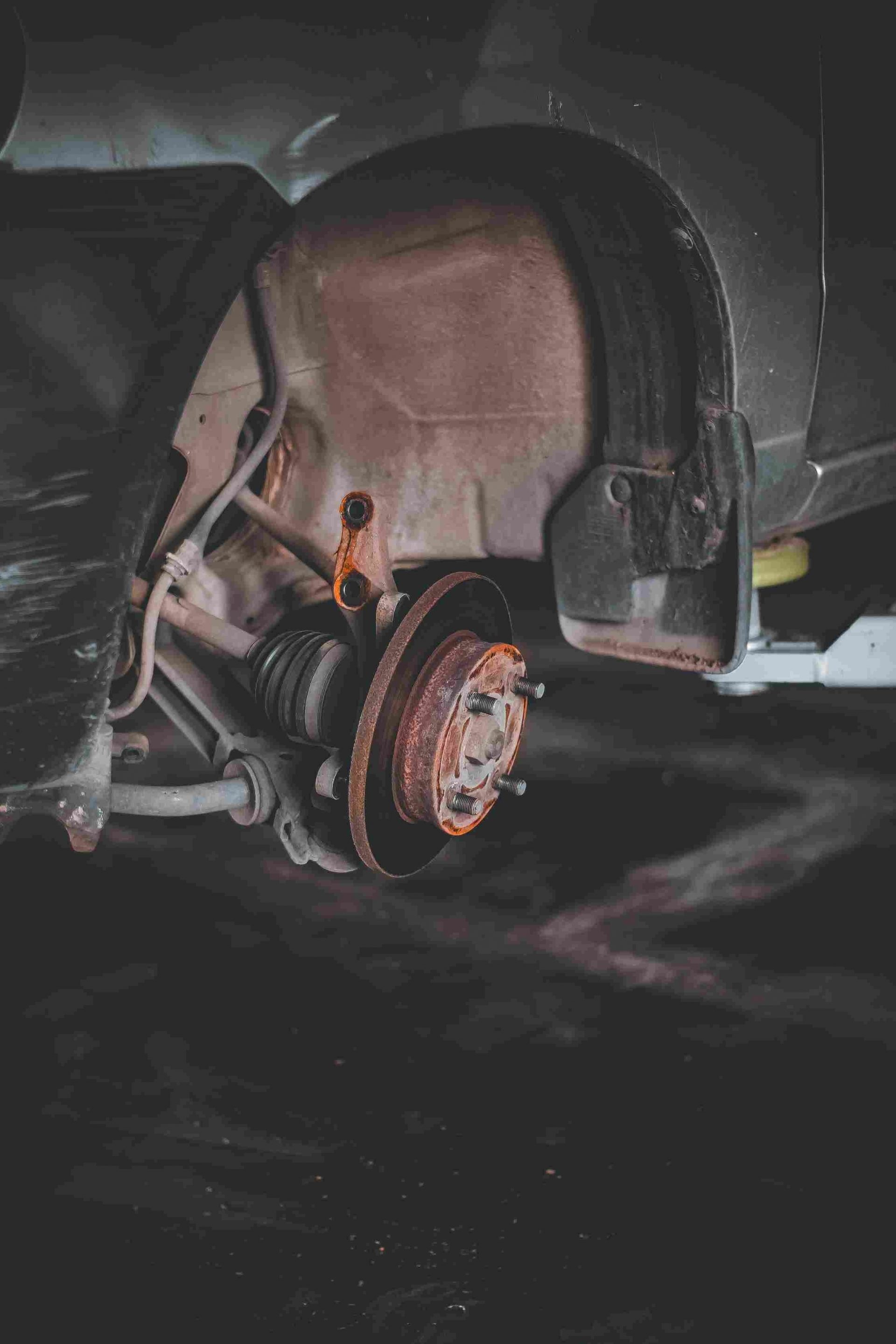 Exposed wheel well of a car showing the rotor.